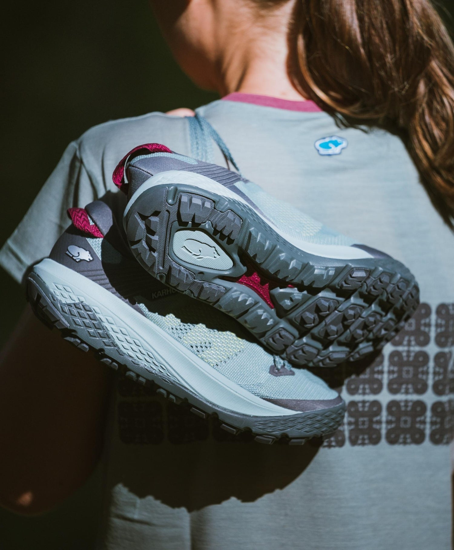 KARHU Ikoni Trail running shoe over the shoulder with sisu t-shirt